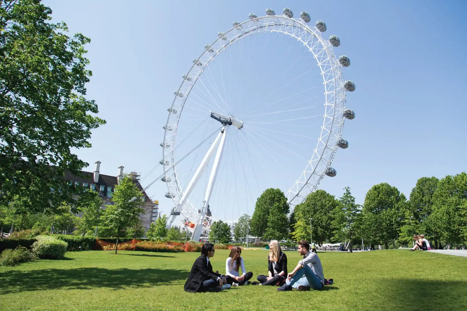 Students-chilling-in-London-park-with-London-eye-in-background